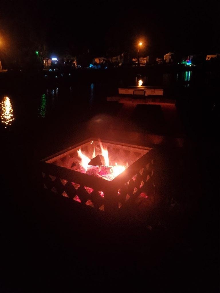 Fire pit at night by the lake at Venice On The Lake