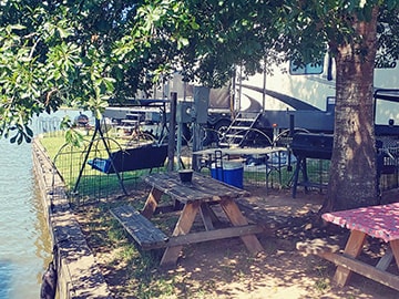 Lakeside picnic tables and RV sites at Venice On The Lake